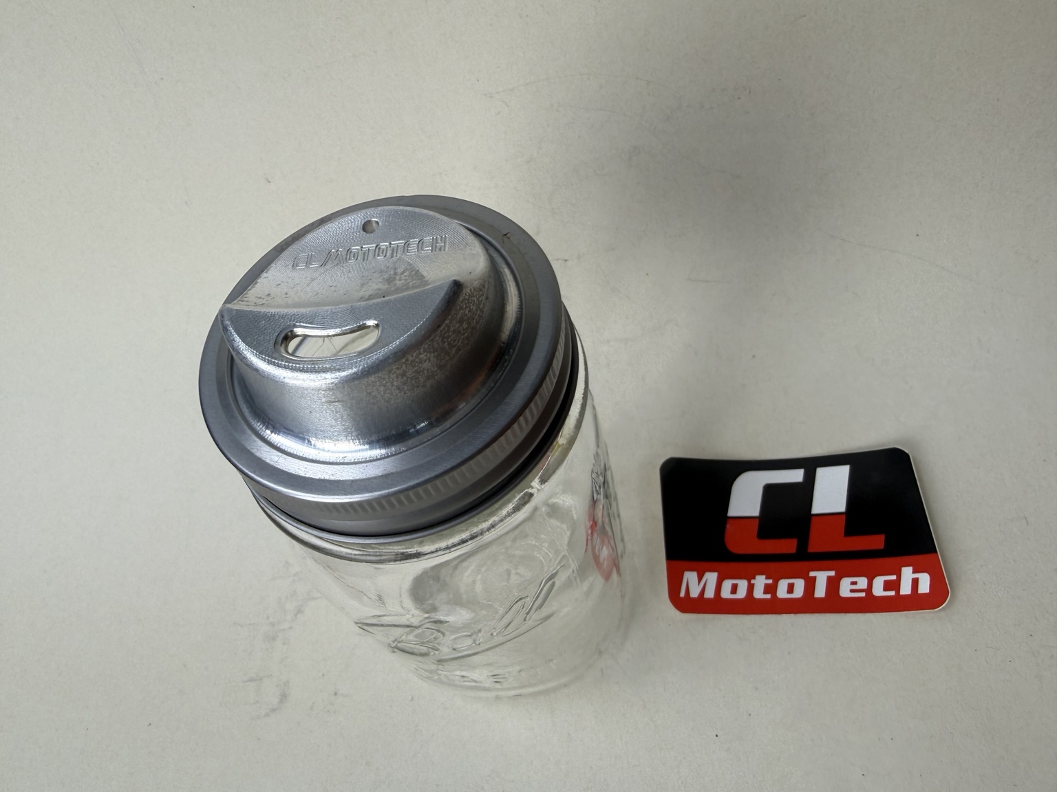 JarMagic aluminum drinking lid fitted to a Ball mason jar with a stainless steel band