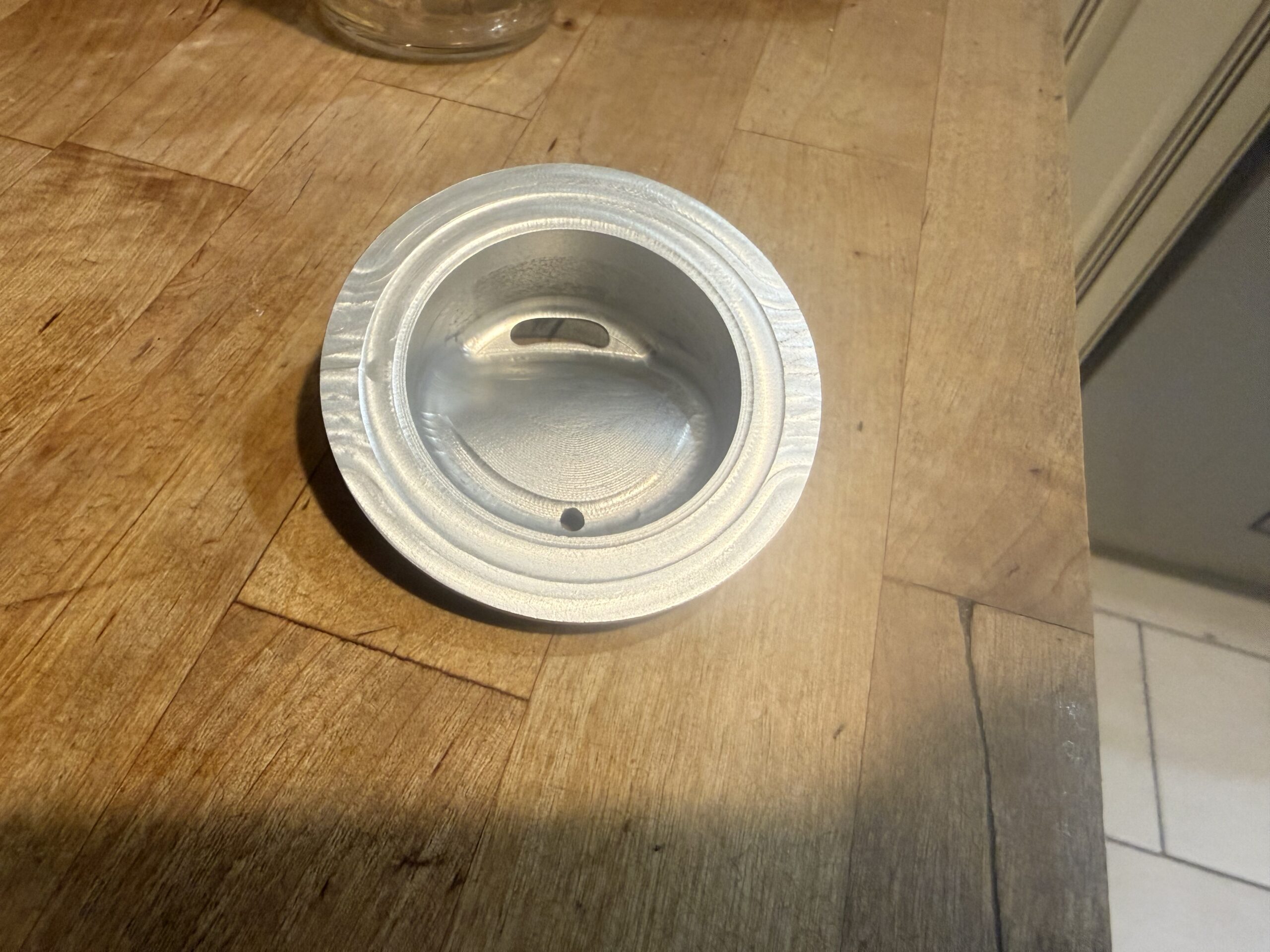 Underside of the anodized JarMagic aluminum lid showing the interior and sealing rim