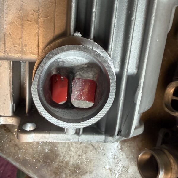 Machined Suzuki GT750 inlet spigot showing a more direct view into the divided inlet port