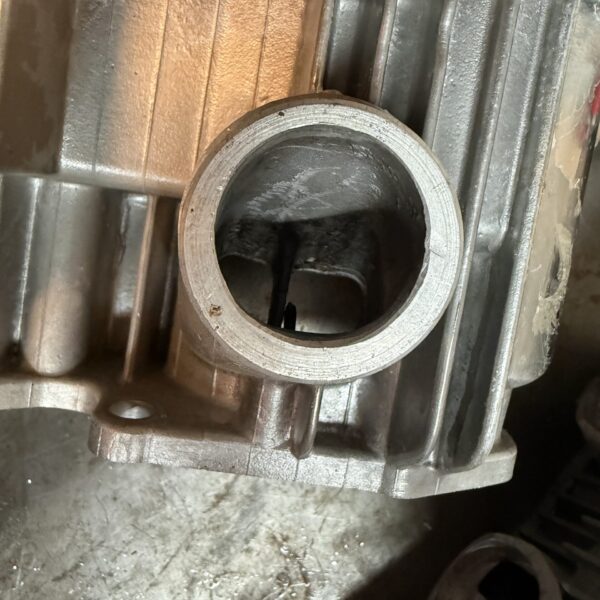 Stock Suzuki GT750 inlet spigot showing the original curved intake passage